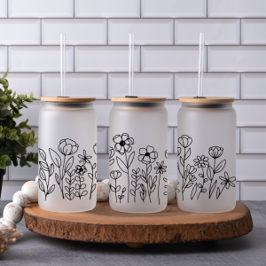 Three glass can tumblers with floral SVG wraps