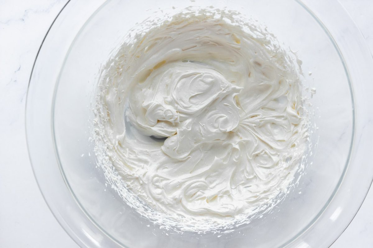 Heavy cream whipped in a glass bowl