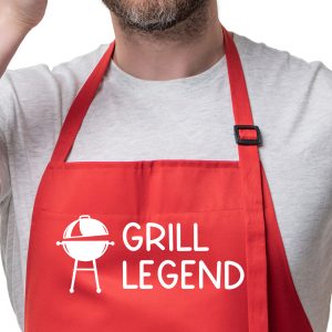 White man wearing a red apron that reads Grill Legend.