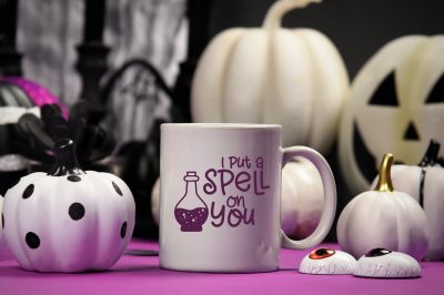 White mug with I Put A Spell On You design near Halloween decor