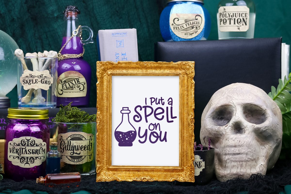 Gold frame containing a I Put A Spell On You print near potion bottles