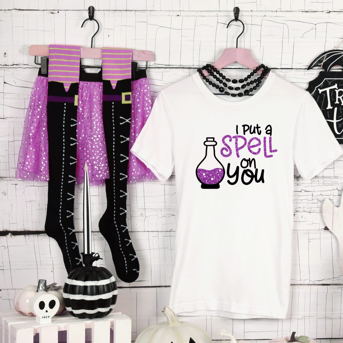 white t-shirt with I Put a Spell On You design near Halloween decor