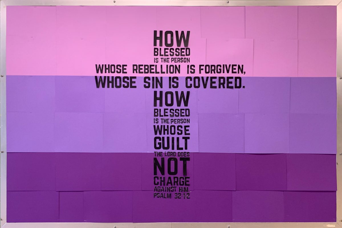Ombre purple bulletin board with a Bible verse in a cross shape