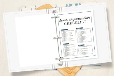 Open 3-ring binder showing a home organization checklist