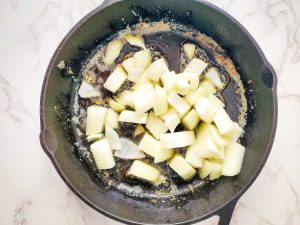 cast iron skillet with chopped onions
