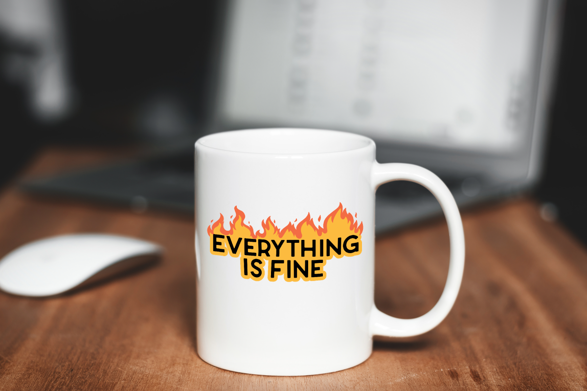 desktop with a white mug with a Everything Is Fine design