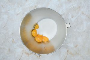stand mixer bowl with cream and eggs