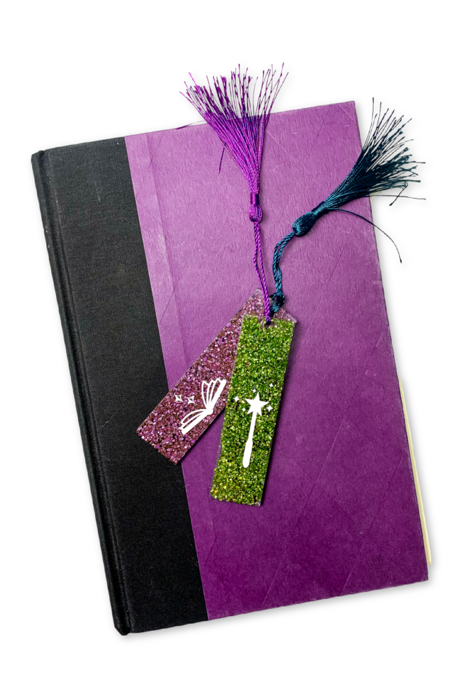Resin bookmarks with tassels on a purple hardcover book