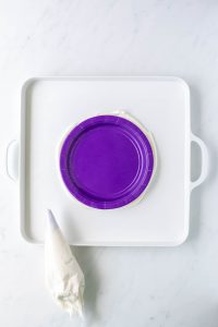 a purple plate on a large white platter