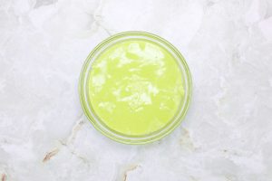Bowl of bright green slime frosting