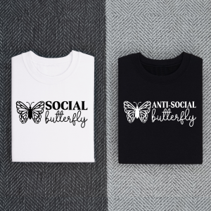 White shirt that says Social Butterfly next to a black shirt that says Antisocial Butterfly
