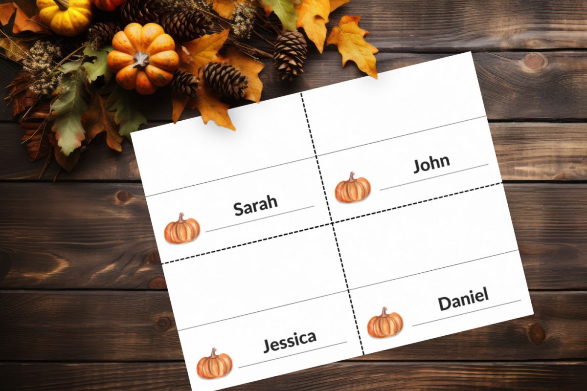 Thanksgiving place cards on a wood background near fall leaves and pumpkins