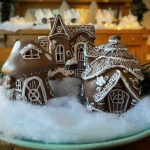 Three fairy houses painted like gingerbread houses on faux snow