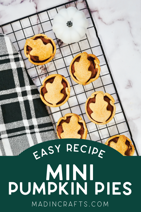 mini pumpkin pies on a cooling rack near a plaid napkin