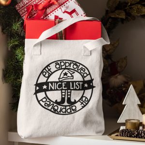 Elf Approved Nice List SVG on a tote bag full of presents