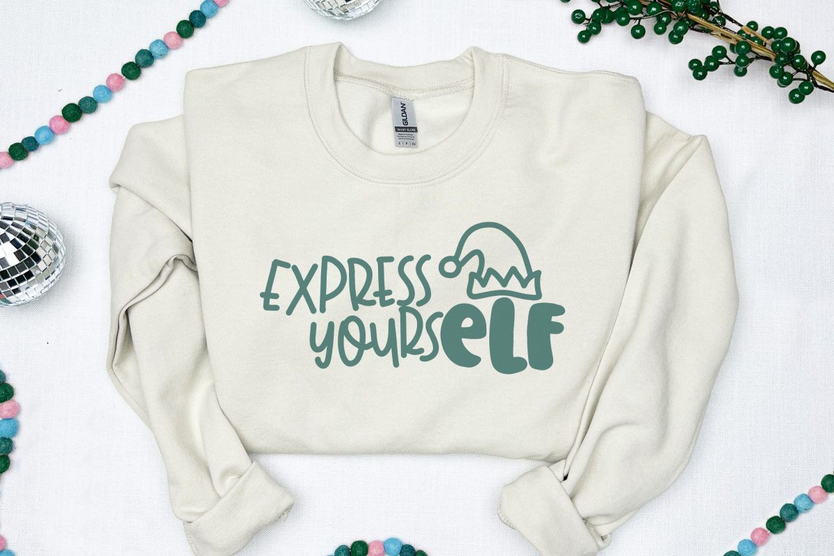 White sweatshirt with Express YoursELF design near Christmas decor
