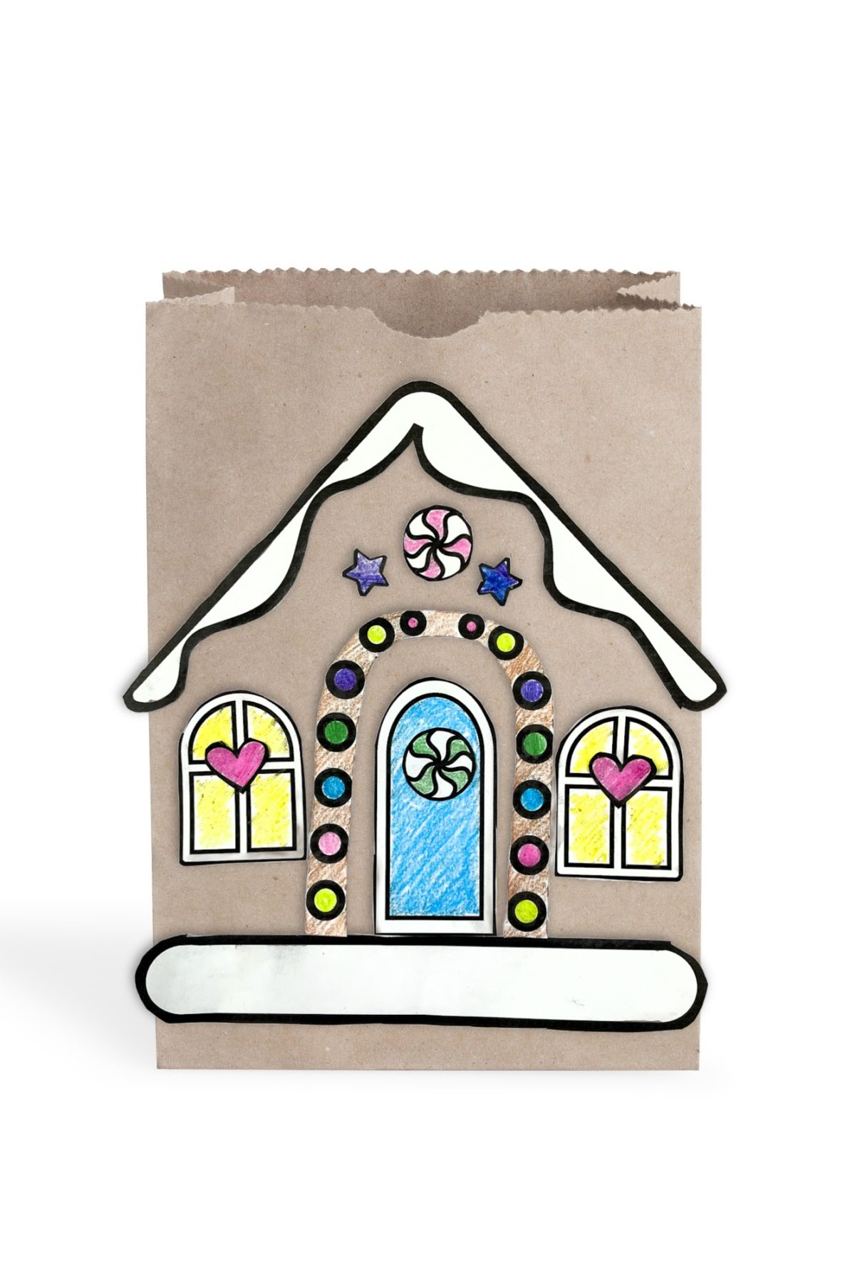 Colored printable gingerbread house pieces on a brown paper bag