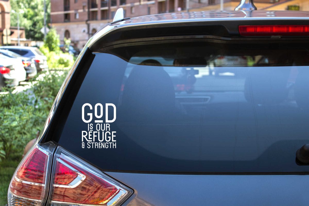 The rear window of an SUV with a decal that says "God is our refuge & strength"