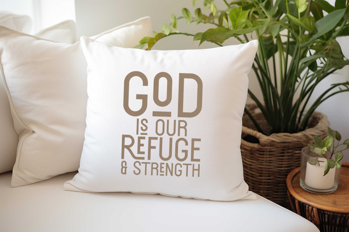 White throw pillow that says "God is our refuge & strength"