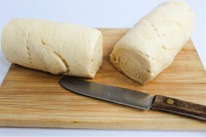 knife near cut log of crescent roll dough