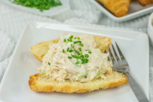 Closeup of open faced chicken salad sandwich on a croissant