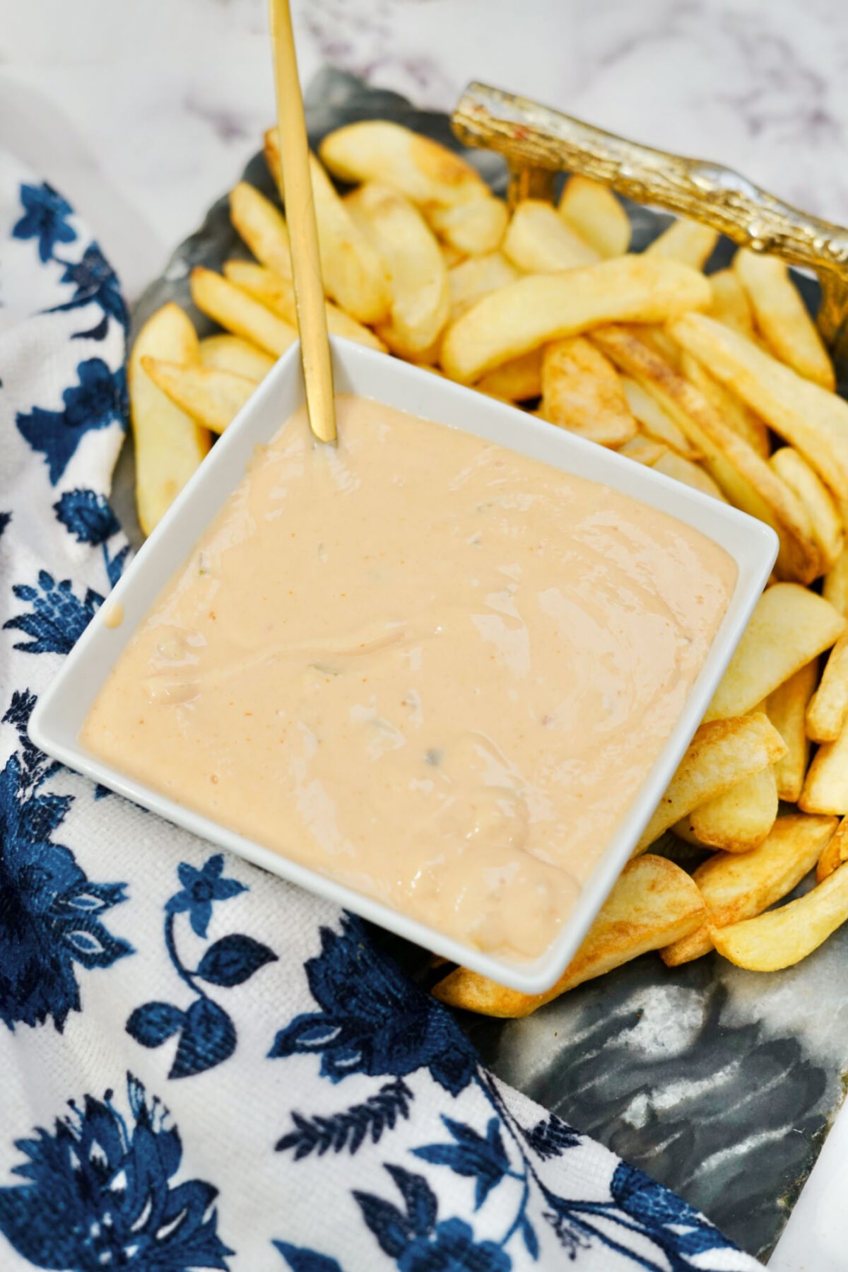 close up of bowl of homemade in-n-out sauce near french fries