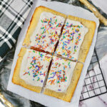 baked and frosted giant pop tart cut into fours