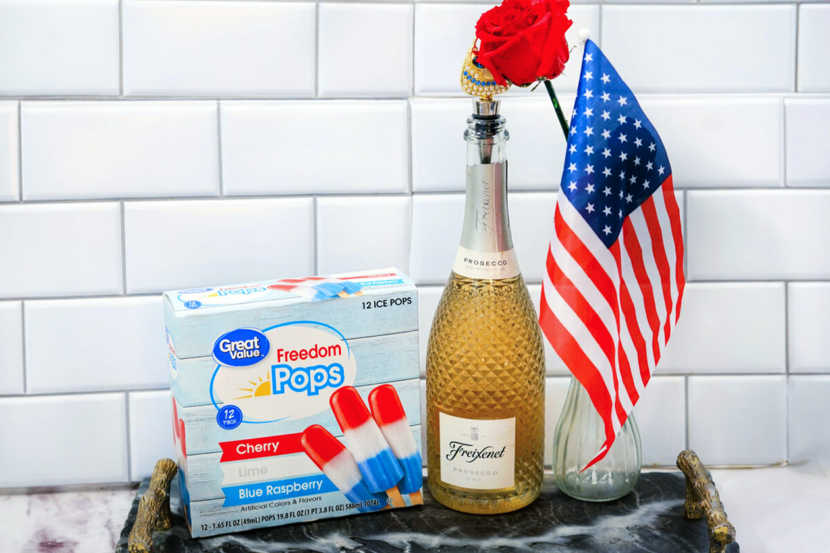 a box of bomb pops and a bottle of champagne on a counter