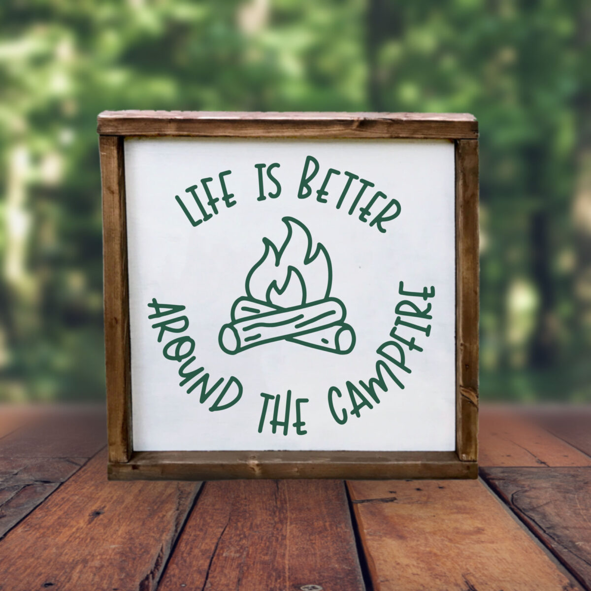 Life is Better Around the Campfire SVG in a rustic wood frame outdoors