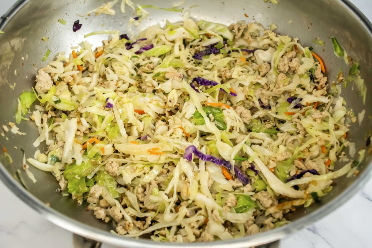 side view cooked egg roll in bowl in a wok