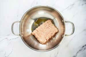 top view of uncooked ground turkey in a wok