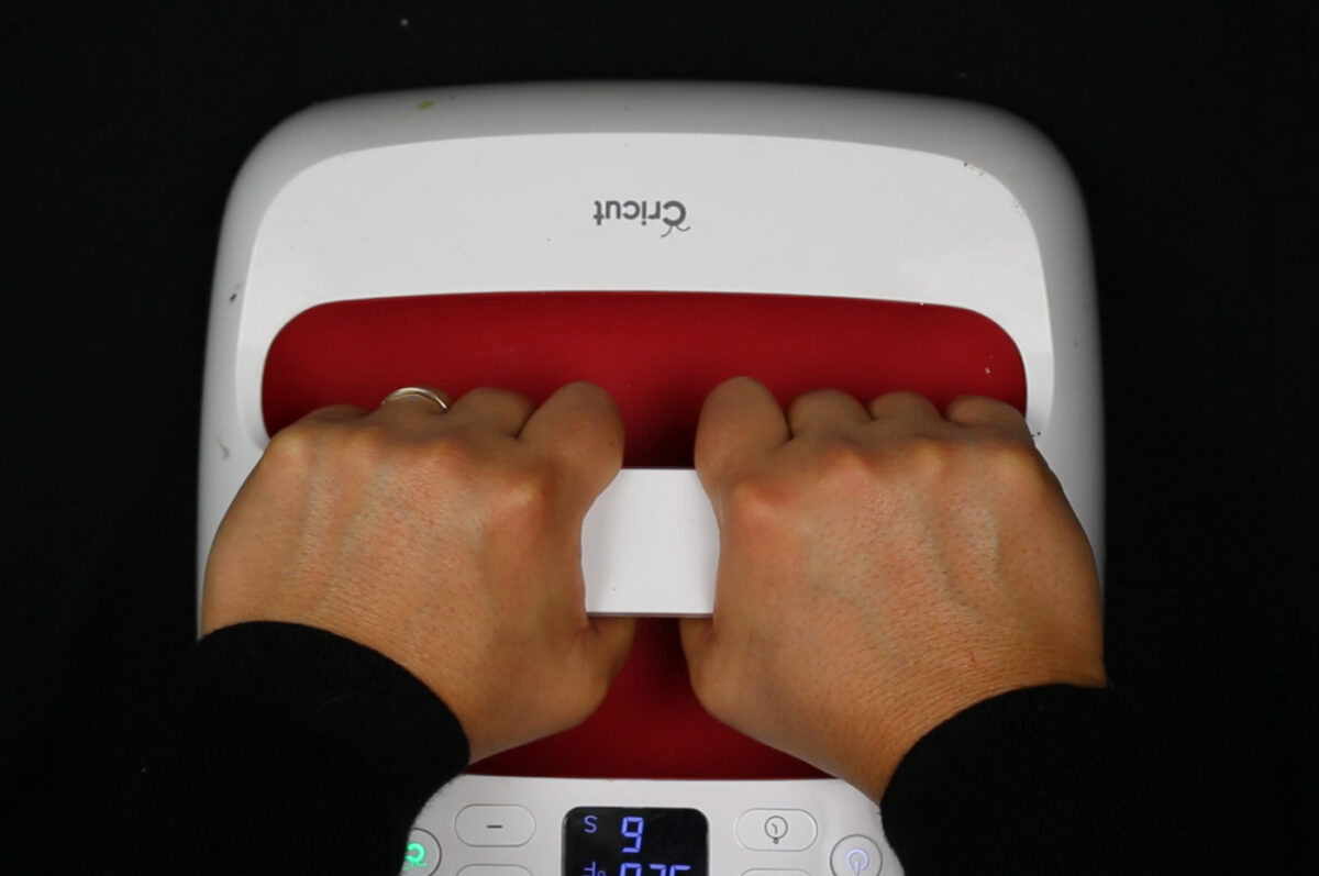 woman's hands using an EasyPress on a black shirt