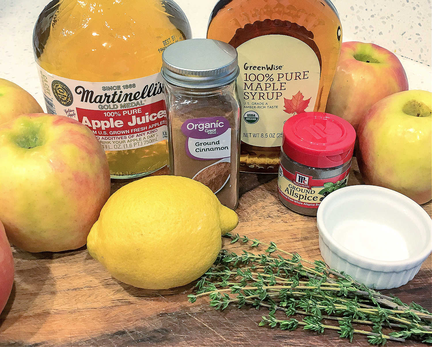 a wooden cutting board covered with apple crisp ingredients