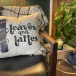 Leaves and Lattes SVG design on a throw pillow on a living room chair