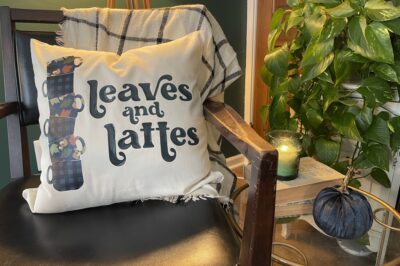 Leaves and Lattes SVG design on a throw pillow on a living room chair