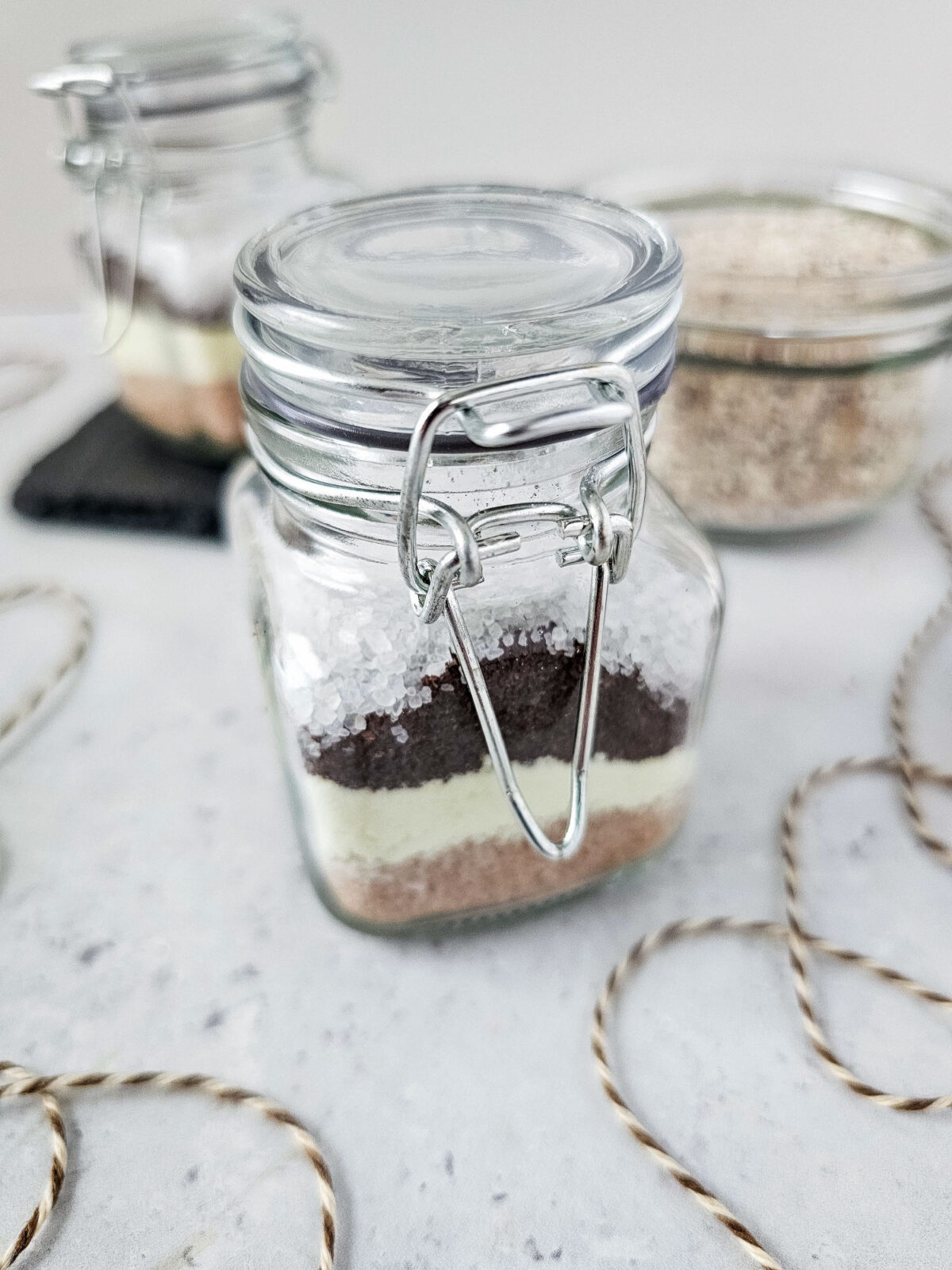 smalled lidded glass jar of layered psl bath soak