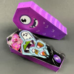 side view of a monster favor box filled with Halloween terats