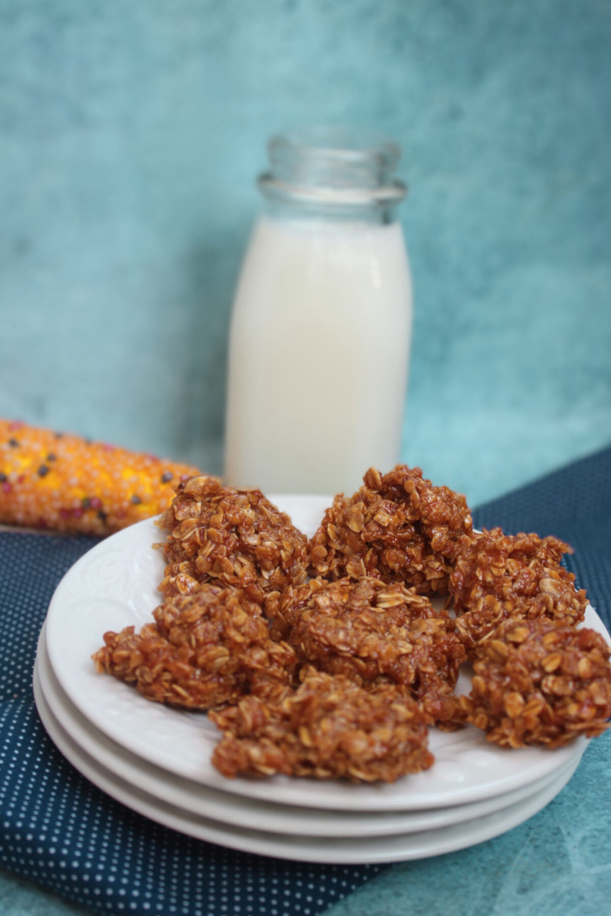 pumpkin no bakes on a white plate near a bottle of milk