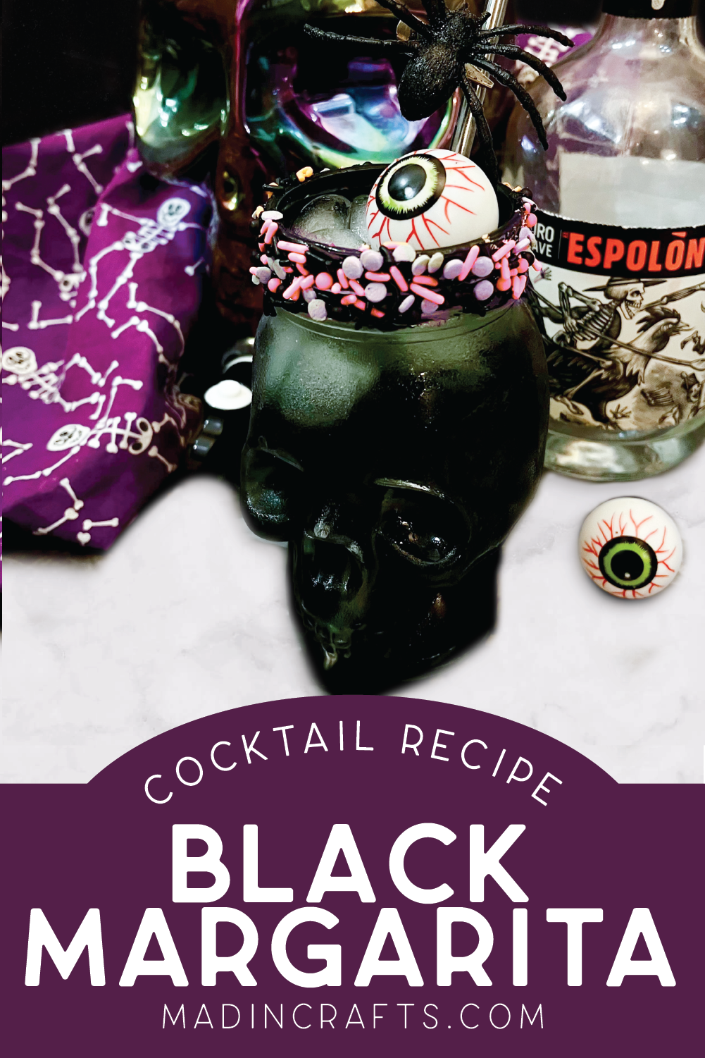 closeup of a black margarita in a skull shaped glass