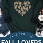 Green sweat shirt with fall heart design near pumpkins