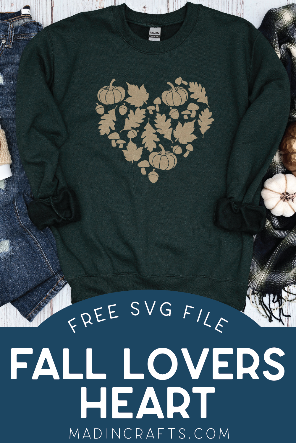 Green sweat shirt with fall heart design near pumpkins