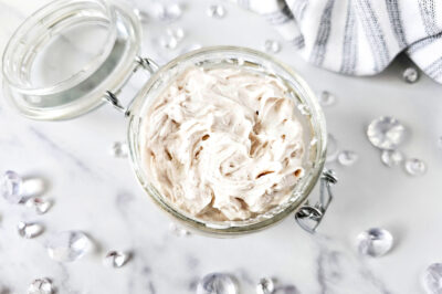 top view of a jar of homemade body butter with the lid open