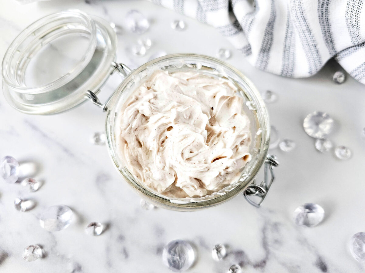 top view of a jar of homemade body butter with the lid open