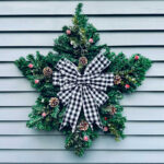 dollar store star wreath on the side of a sided house