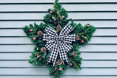 dollar store star wreath on the side of a sided house