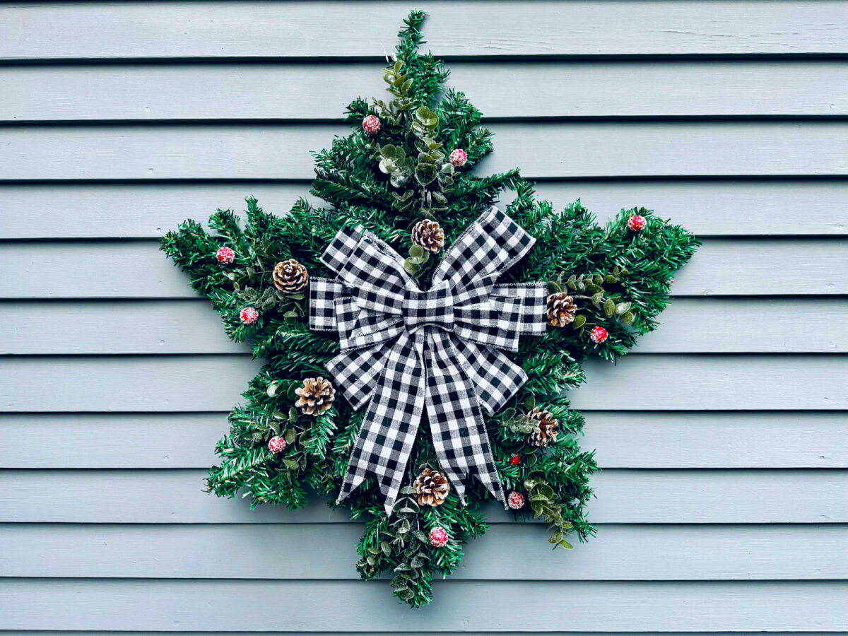 dollar store star wreath on the side of a sided house