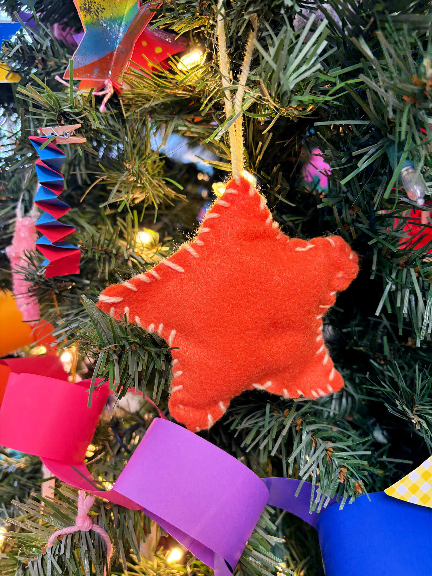 orange felt christmas ornament on a tree