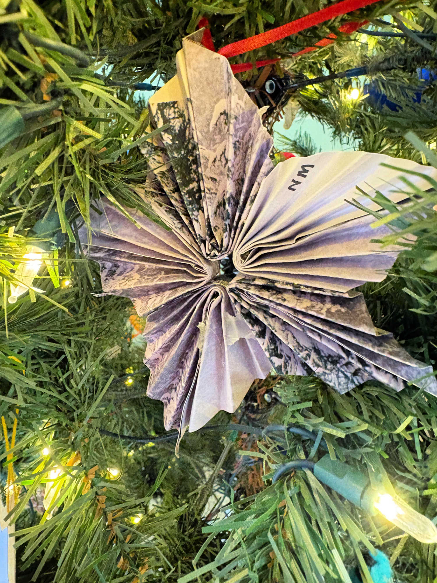 folded paper christmas ornament on a tree