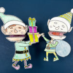 two clothespin elf puppets on a blue background