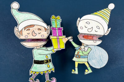 two clothespin elf puppets on a blue background